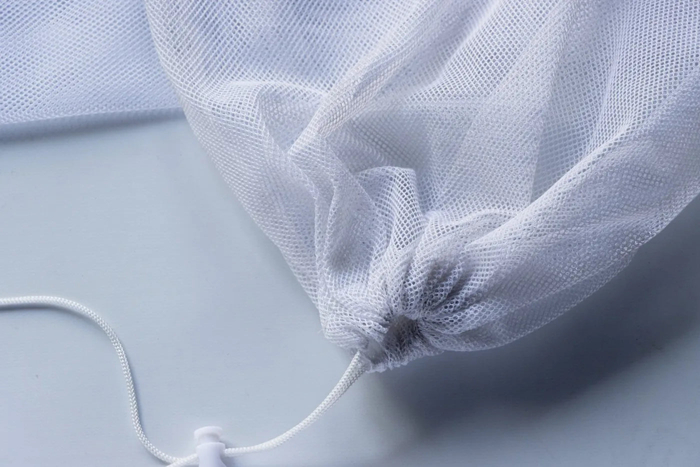 Mesh bag with a drawstring bottom